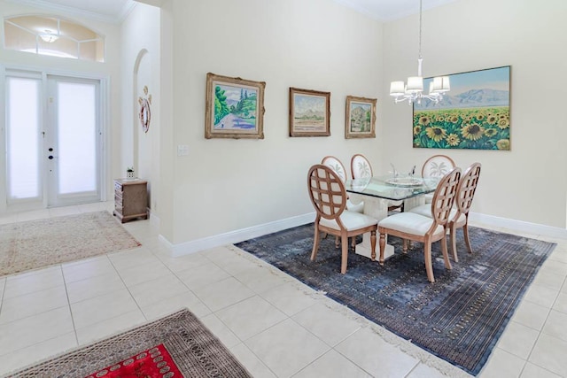 tiled dining room featuring a notable chandelier, baseboards, and ornamental molding