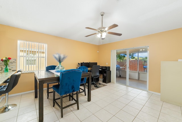 dining space featuring light tile patterned floors, plenty of natural light, and ceiling fan