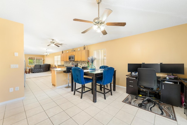 tiled dining space with ceiling fan