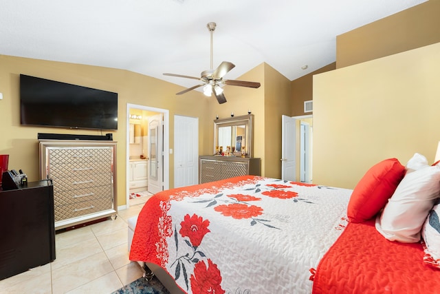 tiled bedroom with ensuite bathroom, ceiling fan, and vaulted ceiling