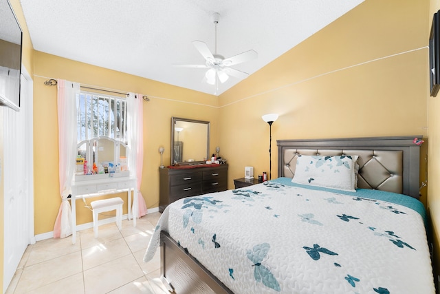 bedroom with light tile patterned floors, ceiling fan, and lofted ceiling