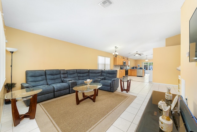 living room featuring ceiling fan with notable chandelier and light tile patterned floors