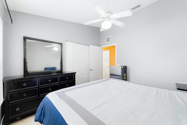 bedroom with ceiling fan, a closet, and light colored carpet