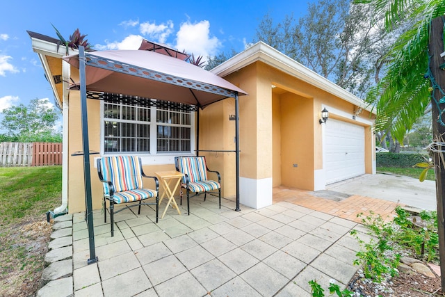 view of patio / terrace with a gazebo and a garage