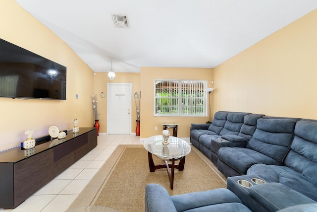 living room featuring lofted ceiling and light tile patterned floors