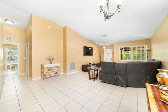 tiled living room with vaulted ceiling and an inviting chandelier