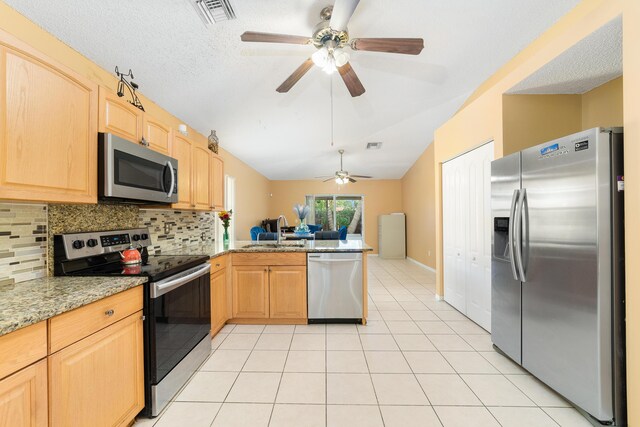 kitchen with light brown cabinets, backsplash, stainless steel appliances, and sink