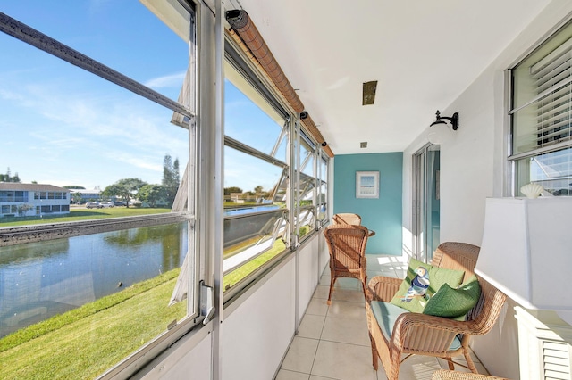 sunroom featuring a water view and a wealth of natural light