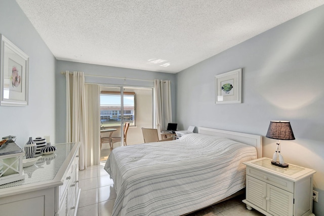 tiled bedroom with a textured ceiling