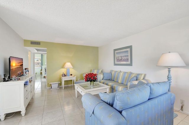 living room with light tile patterned floors and a textured ceiling