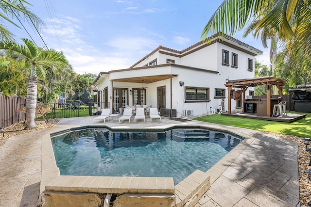 rear view of property featuring a pergola, a fenced in pool, an outdoor bar, and a patio