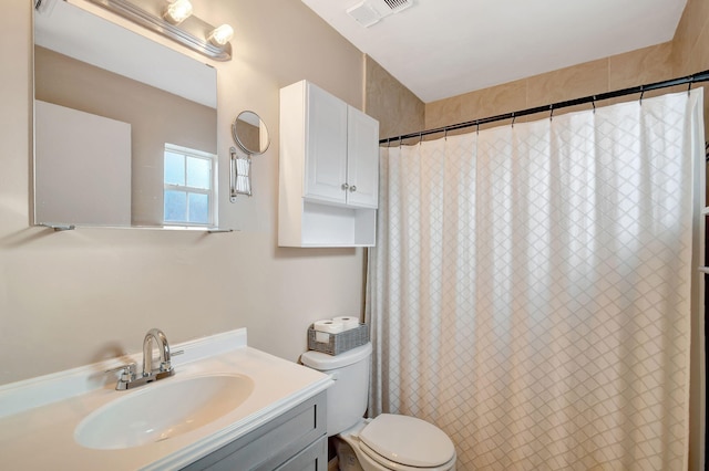 bathroom with vanity, toilet, and walk in shower