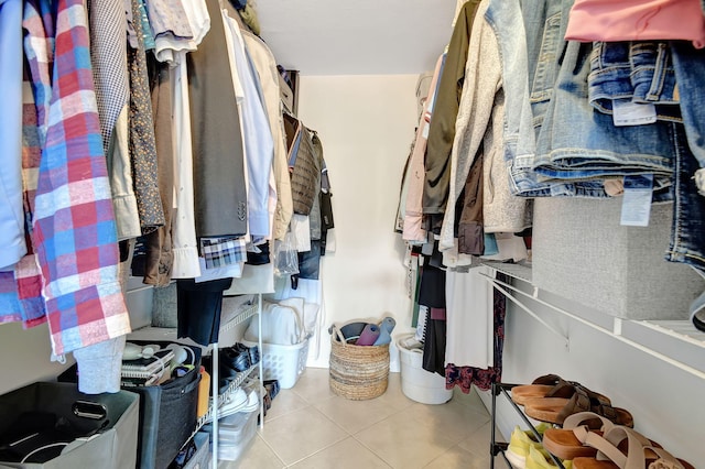 walk in closet with light tile patterned floors