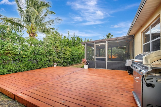 deck featuring grilling area and a sunroom