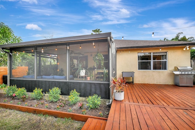 back of house featuring a wooden deck and a sunroom