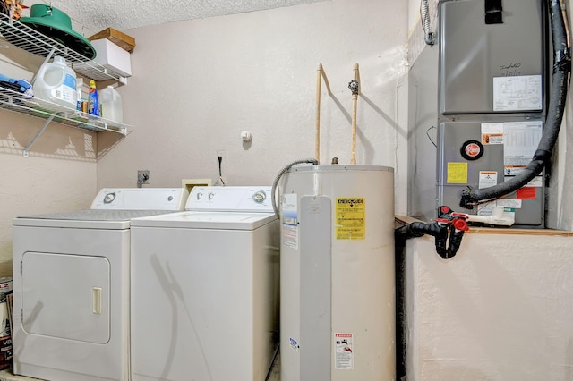 laundry area featuring washing machine and dryer, electric water heater, a textured ceiling, and heating unit