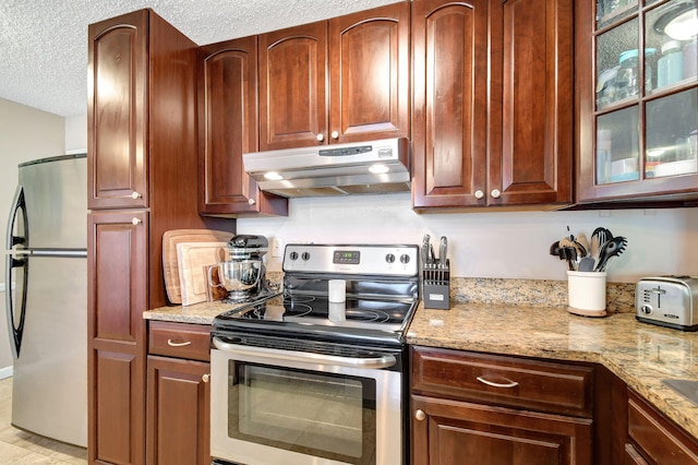 kitchen with light stone countertops, a textured ceiling, and appliances with stainless steel finishes