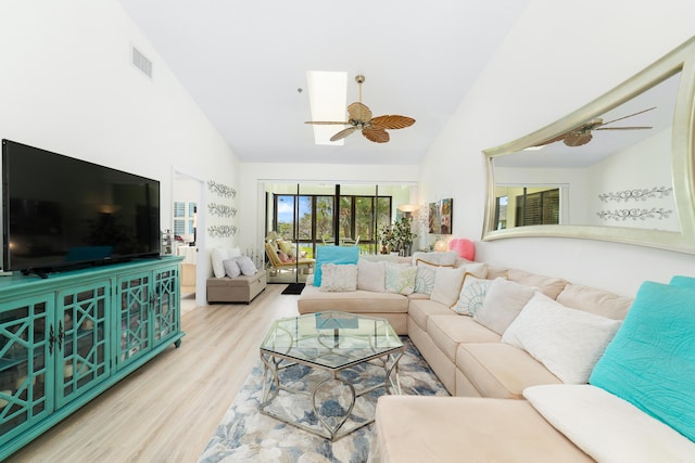 living room featuring light hardwood / wood-style flooring and high vaulted ceiling