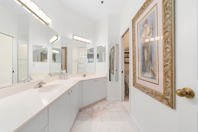 bathroom with tile patterned floors, vanity, and toilet