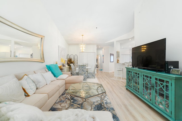 living room featuring light hardwood / wood-style flooring and a notable chandelier