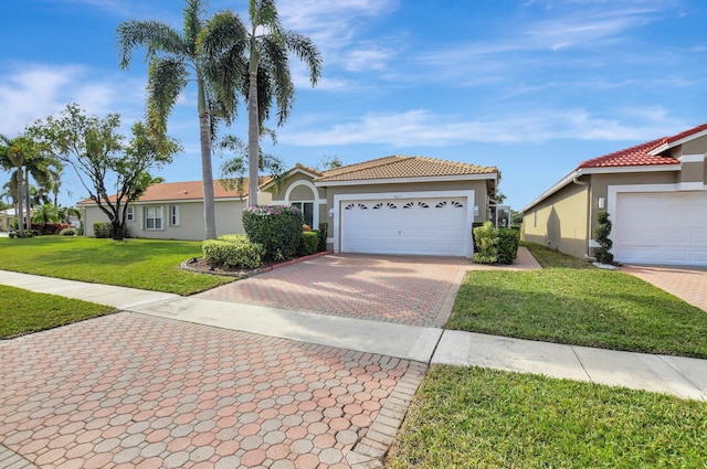 view of front of home with a front yard and a garage