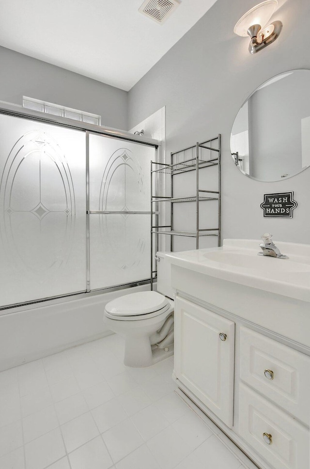 full bathroom with shower / bath combination with glass door, tile patterned floors, vanity, and toilet