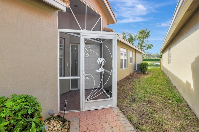 doorway to property featuring central AC unit