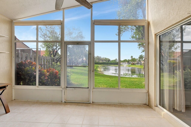 unfurnished sunroom with a water view and vaulted ceiling