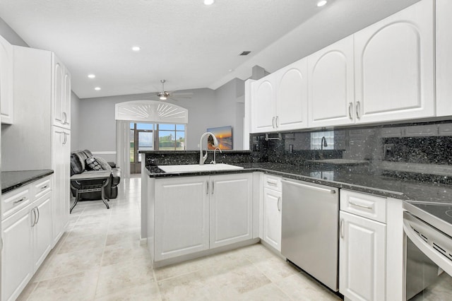 kitchen featuring sink, kitchen peninsula, stainless steel dishwasher, ceiling fan, and white cabinetry