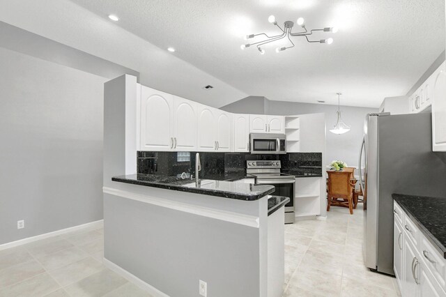 kitchen featuring dark stone counters, range, white cabinets, tasteful backsplash, and stainless steel fridge with ice dispenser