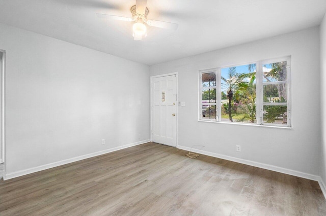 spare room with ceiling fan and wood-type flooring