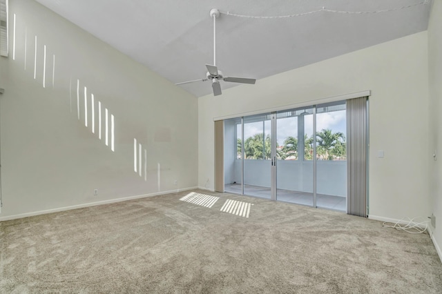 carpeted empty room with ceiling fan and lofted ceiling