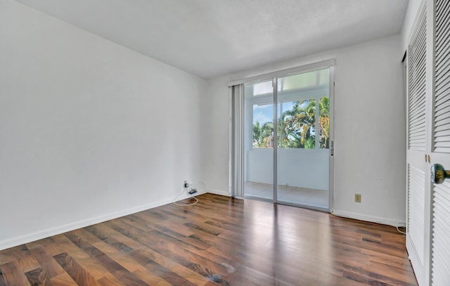 interior space featuring access to outside and dark hardwood / wood-style floors