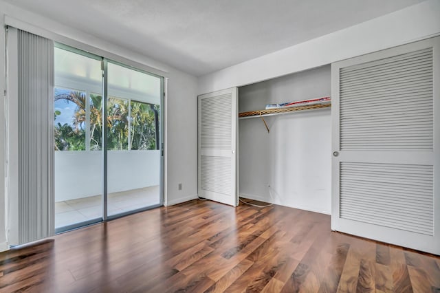 unfurnished bedroom featuring dark wood-type flooring