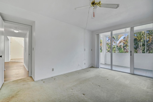 unfurnished room featuring ceiling fan and light carpet