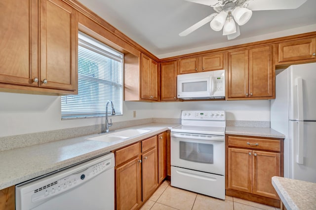 kitchen with sink, white appliances, ceiling fan, and light tile patterned flooring