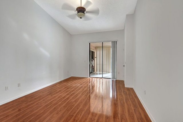 spare room with baseboards, a textured ceiling, a ceiling fan, and wood finished floors