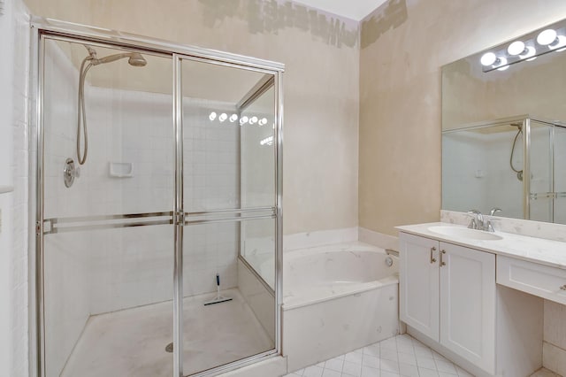 bathroom featuring a garden tub, a shower stall, vanity, and tile patterned floors