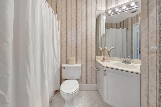 full bathroom featuring toilet, vanity, baseboards, tile patterned floors, and wallpapered walls