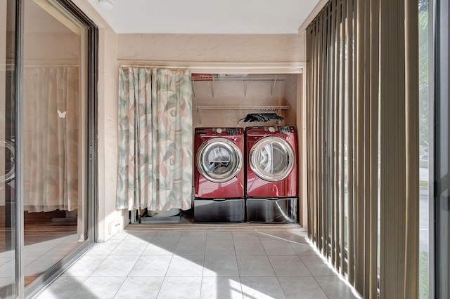 washroom with light tile patterned floors and separate washer and dryer