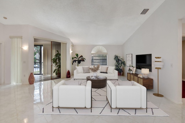 living area with marble finish floor, lofted ceiling, visible vents, a textured ceiling, and baseboards