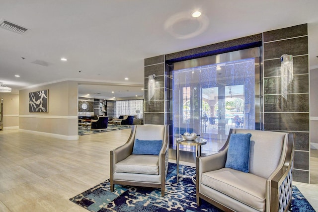 living area with a wealth of natural light, recessed lighting, visible vents, and baseboards