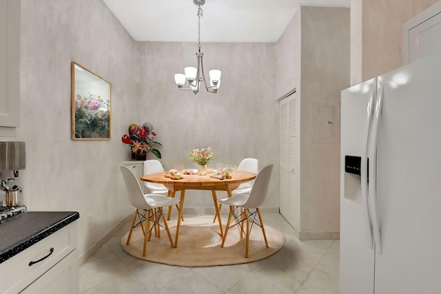 dining area with marble finish floor, baseboards, and a chandelier