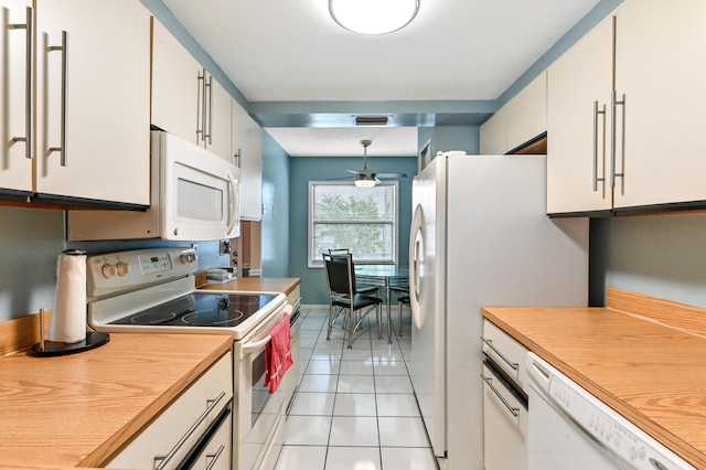 kitchen featuring hanging light fixtures, white appliances, white cabinets, ceiling fan, and light tile patterned flooring