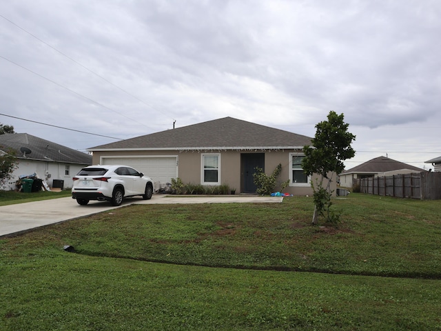 single story home with a front yard and a garage