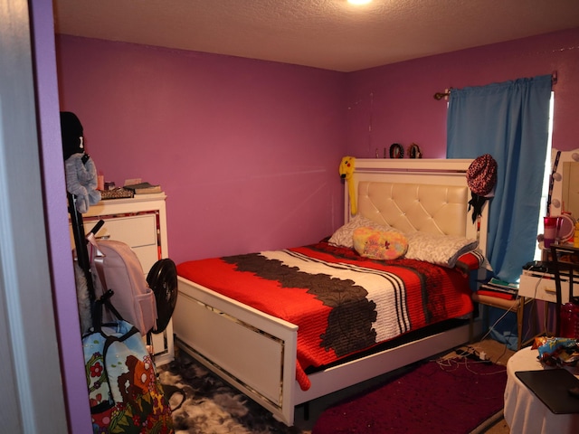 bedroom featuring carpet and a textured ceiling