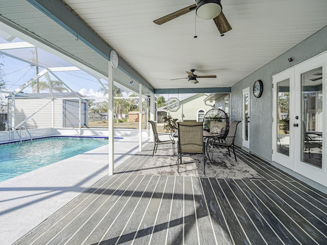 view of swimming pool featuring french doors, a shed, a lanai, and a patio area