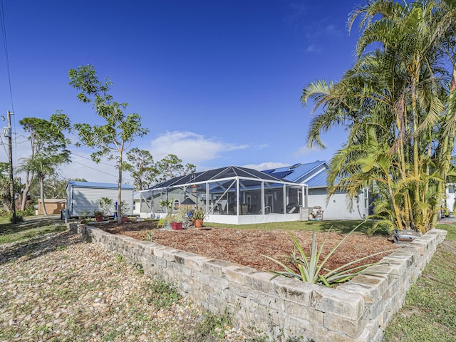 back of house featuring glass enclosure