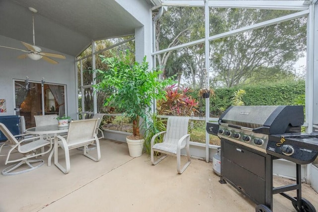 view of patio with ceiling fan and a lanai