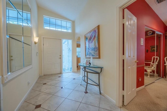 tiled foyer with vaulted ceiling